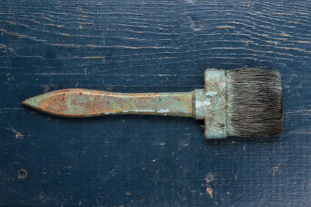 old brush on the blue wooden tableの写真素材