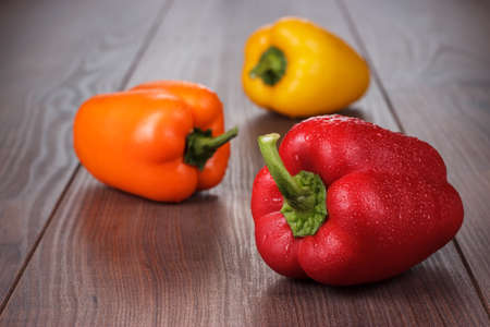 sweet peppers on the brown wooden tableの写真素材