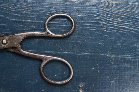 old black scissors on the wooden backgroundの写真素材