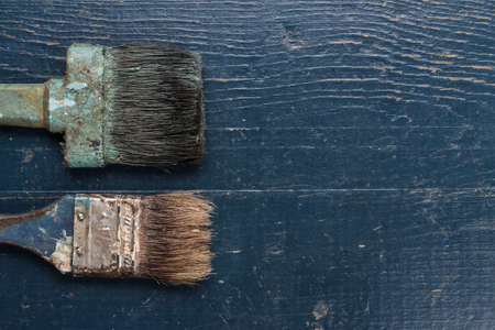 old brushes on the blue wooden tableの写真素材