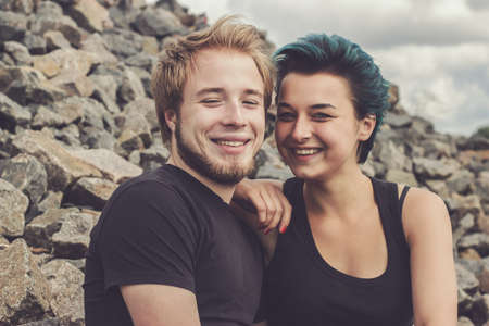 young happy loving couple on the river bankの写真素材
