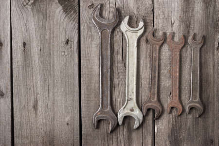 old rusty screw keys on the wooden table