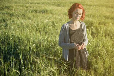 beautiful girl and green field in the morning