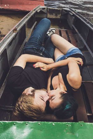 happy loving couple lying in the boatの写真素材