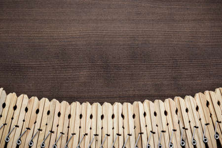 wooden clothes pegs on the brown tableの写真素材