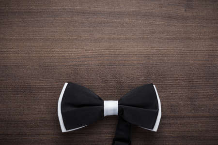 black and white bow tie on wooden tableの写真素材