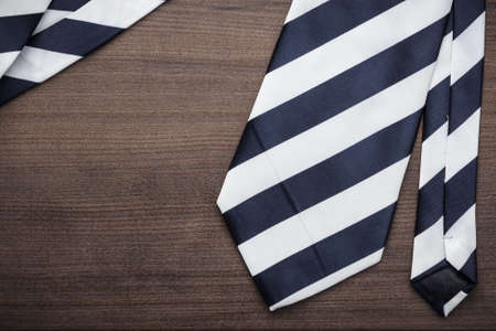 black and white striped necktie on the wooden table