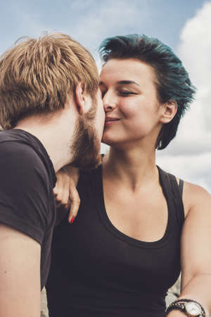 young happy loving couple on the river bank