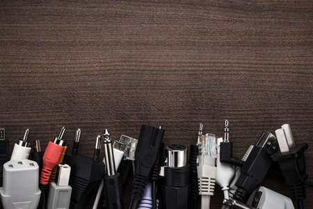 different cables on the brown wooden tableの写真素材