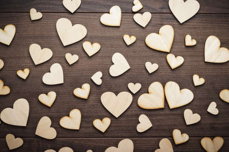 wooden heart shapes on the brown tableの写真素材