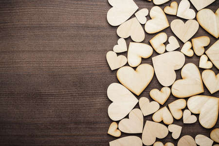 wooden heart shapes on the brown tableの写真素材