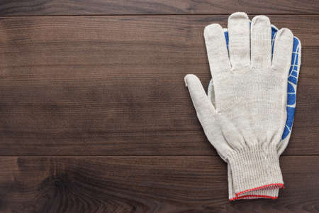 working gloves on the brown wooden backgroundの写真素材