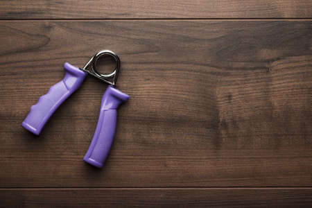 hand expander on the brown wooden table