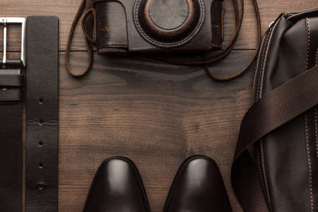 brown shoes, belt, bag and film camera with copy space