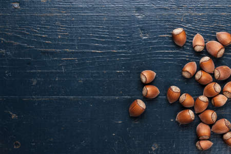 hazelnuts on the blue wooden table backgroundの写真素材