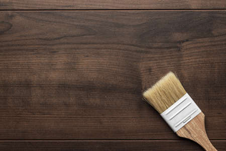 new paint brush on the brown wooden table backgroundの写真素材