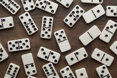 domino pieces on the brown wooden table backgroundの写真素材