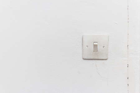 old light switch on the white wallの写真素材