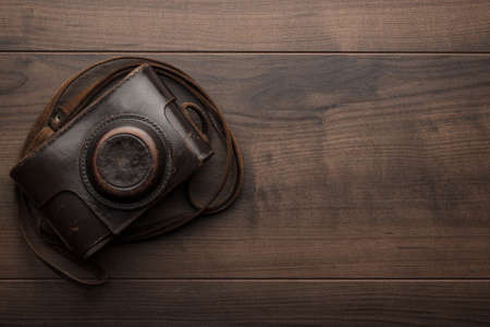 wooden background with retro still camera in caseの写真素材