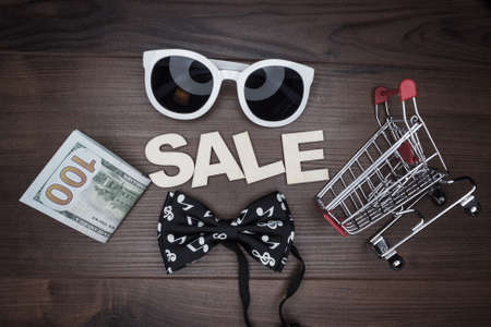 sale concept on the wooden background. shopping trolleyの写真素材