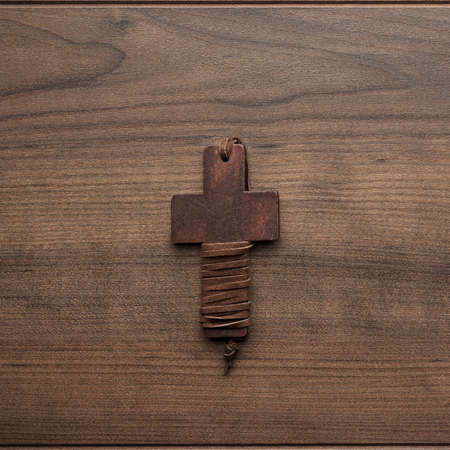 wooden cross on the brown table backgroundの写真素材