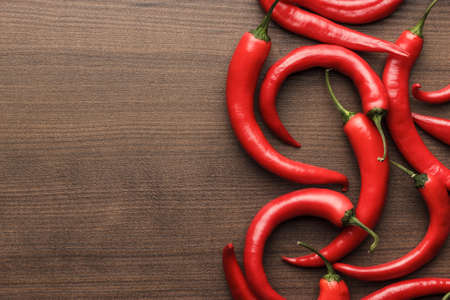 red hot chilli peppers on the wooden table with copy space