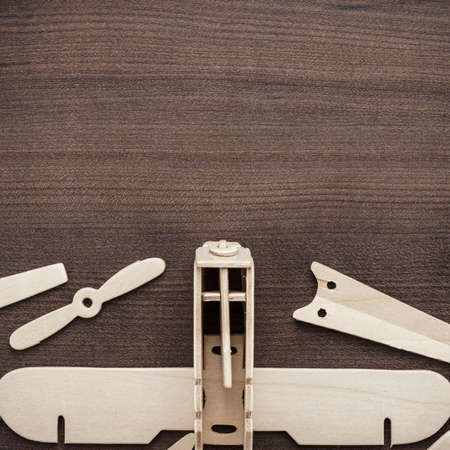 handmade airplane on the brown wooden tableの写真素材
