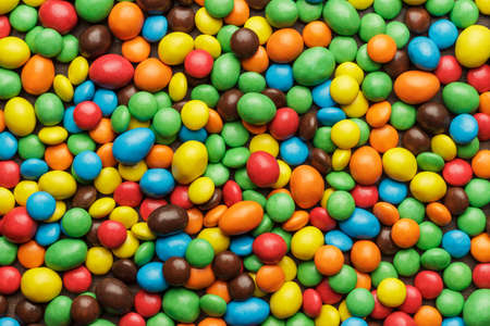 many colorful sweets on the table background