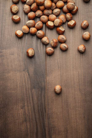 hazelnuts on the brown wooden table background