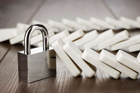 padlock standing still reliability concept on wooden tableの写真素材