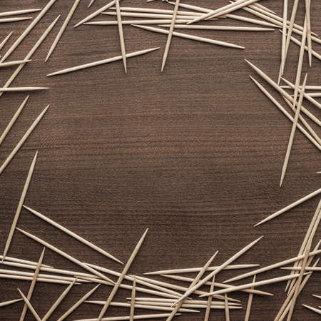 many wooden toothpicks on the brown table backgroundの写真素材