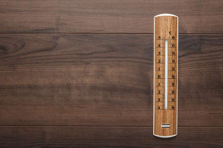 wooden thermometer on the brown table backgroundの写真素材