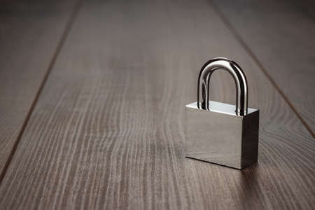check-lock on the brown wooden table background