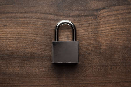 check-lock on the brown wooden table backgroundの写真素材