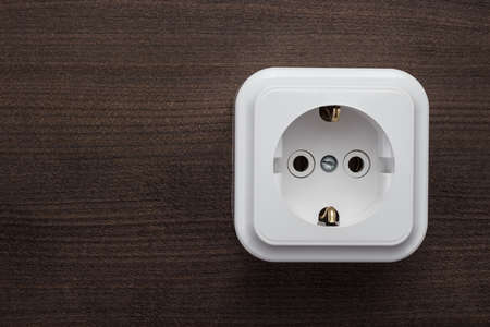 white plastic power socket on the wall