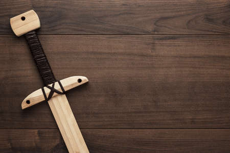 handmade wooden training toy sword on the tableの写真素材