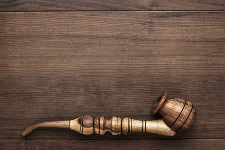 wooden handmade smoking pipe on the tableの写真素材