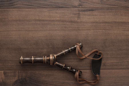 handmade wooden slingshot on the brown tableの写真素材