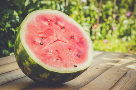 half of watermelon on the wooden tableの写真素材