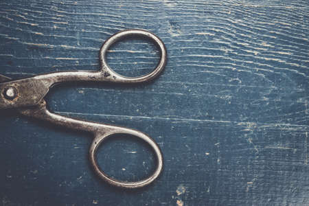 old black scissors on the wooden backgroundの写真素材
