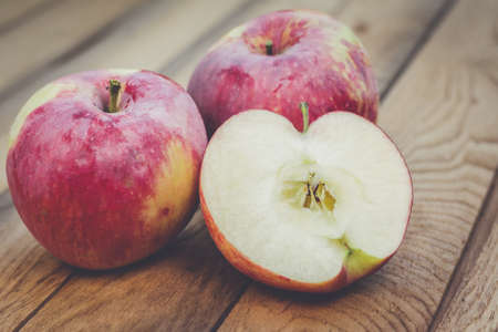 fresh red apples on the wooden tableの写真素材