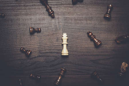 chess figures on brown woden table conceptの写真素材