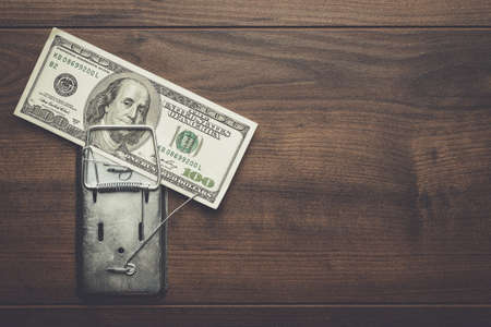 one hundred dollars banknote as a bait in mousetrapの写真素材