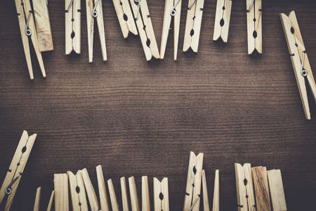 wooden clothes pegs on the brown tableの写真素材