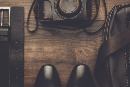 brown shoes, belt, bag and film camera with copy space