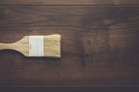 new paint brush on the brown wooden table backgroundの写真素材