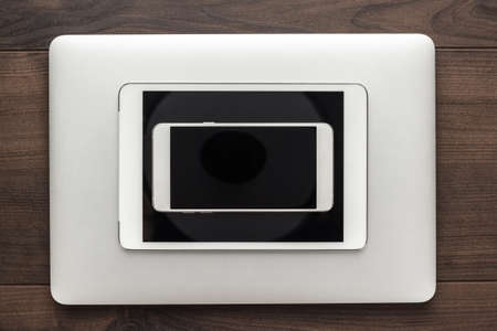 laptop, tablet computer and smartphone on the wooden tableの写真素材