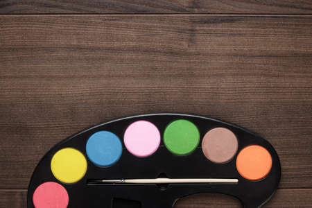 watercolors and brush on the wooden tableの写真素材