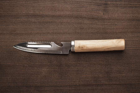multifunctional kitchen knife on the wooden tableの写真素材