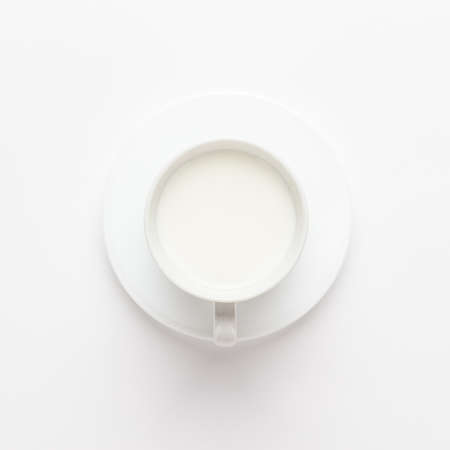 cup of milk on white background. not isolated. view from aboveの写真素材